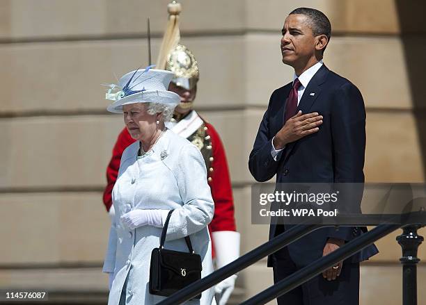 Queen Elizabeth II and US President Barack Obama review an honour guard of the First Battalion Scots Guards at a ceremony of welcome at Buckingham...