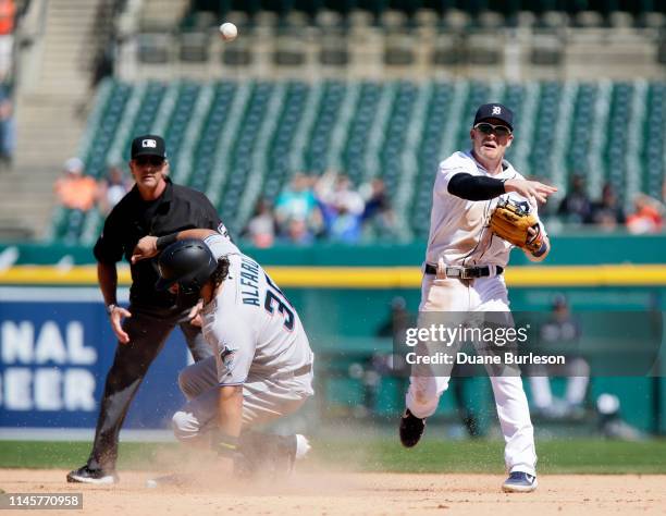 Shortstop Gordon Beckham of the Detroit Tigers turns the ball after getting a force out on Jorge Alfaro of the Miami Marlins with umpire Paul Nauert...