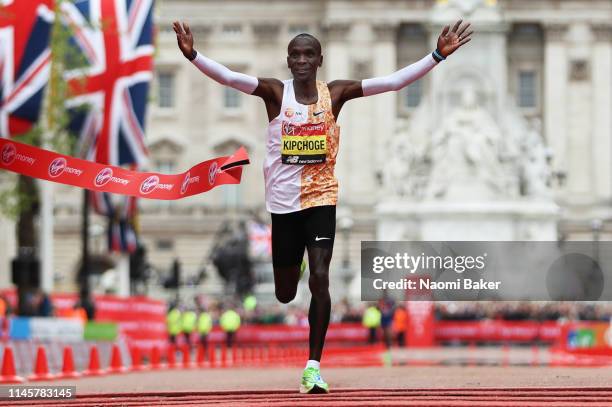 Eliud Kipchoge of Kenya crosses the finish line to win the Men's Elite race breaking the race record during the Virgin Money London Marathon at...