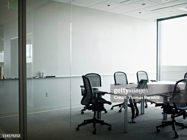 empty office conference room with phone on table - silla vacía fotografías e imágenes de stock