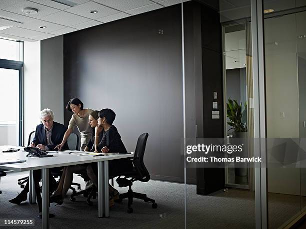 group of coworkers in discussion in office - mature business woman digital tablet corporate professional stockfoto's en -beelden