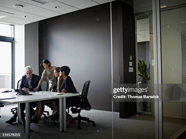 group of coworkers in discussion in office - thomas barwick meeting stock pictures, royalty-free photos & images