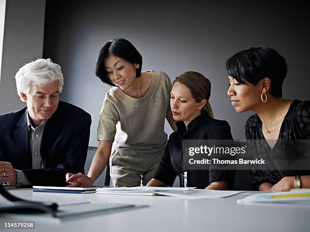 group of coworkers in discussion in office - board room meeting stock-fotos und bilder