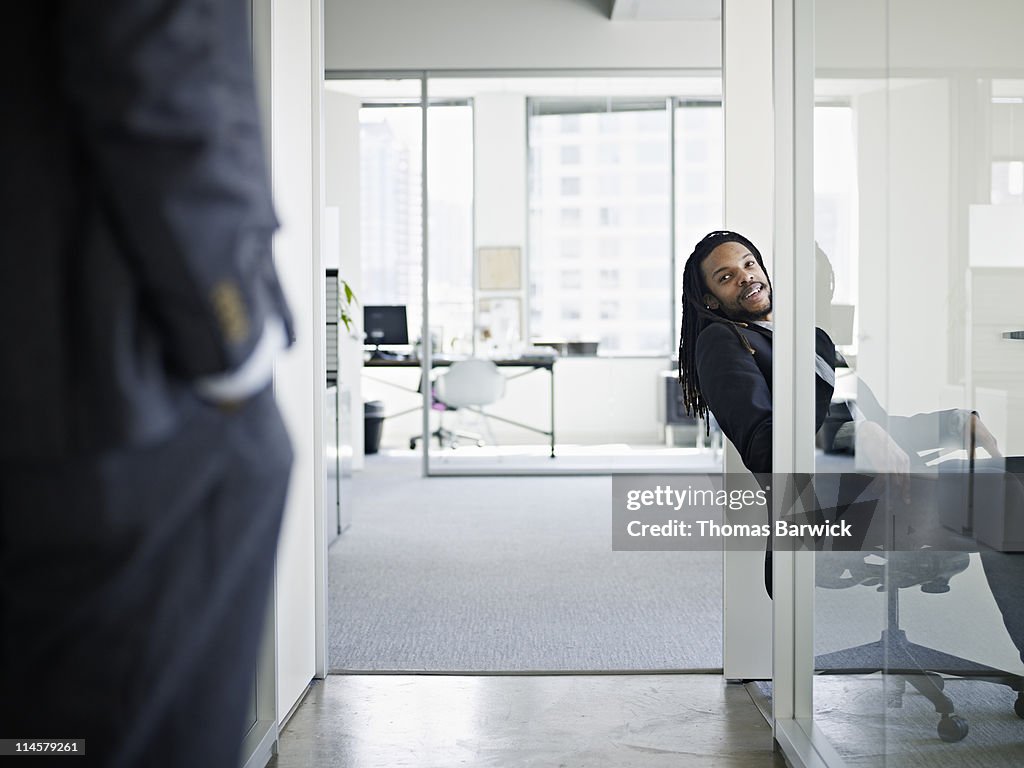 Businessman sitting in discussion with coworker