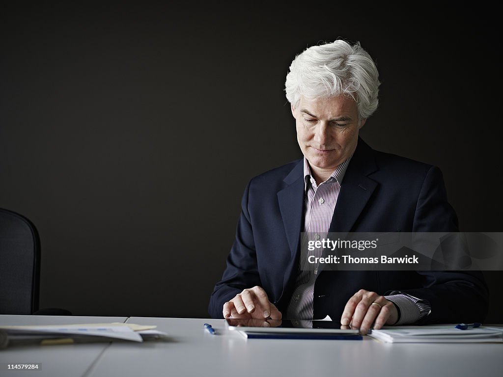 Businessman sitting at table working