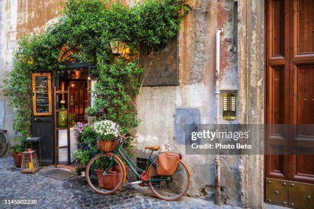 a lovely italian restaurant in the ancient trastevere district in the historic center of rome - italian cafe culture stock pictures, royalty-free photos & images