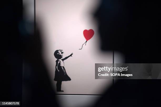 Painting of 'Girl with a balloon' seen during the exhibition. 'Banksy The art of Protest' at cultural center 'La Térmica' is an exhibition showing...