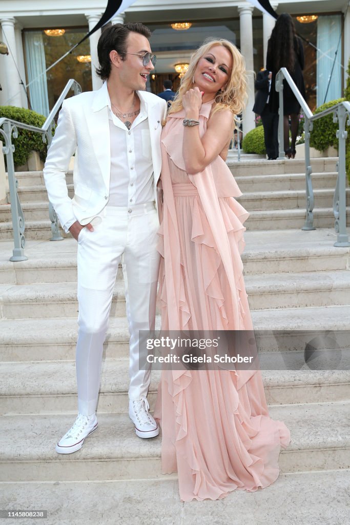 Pamela Anderson and her son Brandon Lee attend the amfAR Cannes Gala