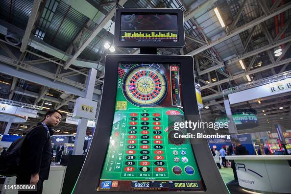 Panel Game Roulette An attendee walks past an electronic panel showing a game of roulette ...