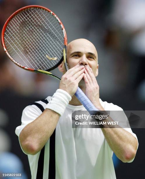 Andre Agassi of the US blows kisses at the crowd following his victory over Rainer Schuettler of Germany in the men's singles final at the Australian...