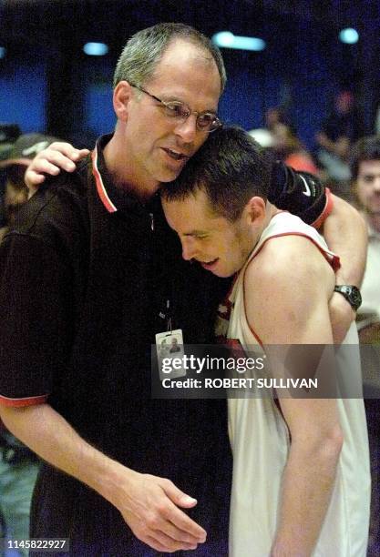 Canada's head coach Jat Triano and player Steve Nash hug after their 83-71 win over Puerto Rico during the final seconds of their semi-final match at...