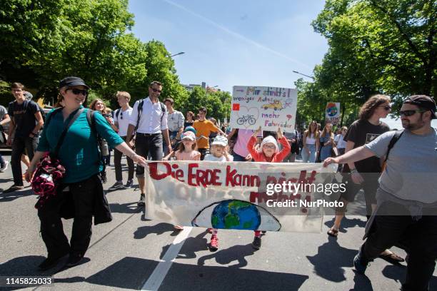Little children with their parents with signs and a banner. On 24.5.2019 ten thousands protested in Munich for the protection of the climate and of...