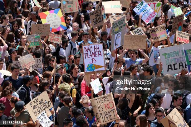 Portuguese students chant and hold up placards while marching towards the Portuguese Parliament during the 'Global Strike For Future' demonstration...