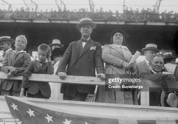 View of New York governor Al Smith stands with his wife Catherine Ann Dunn, at an unidentified venue, early twentieth century. They stand among a...