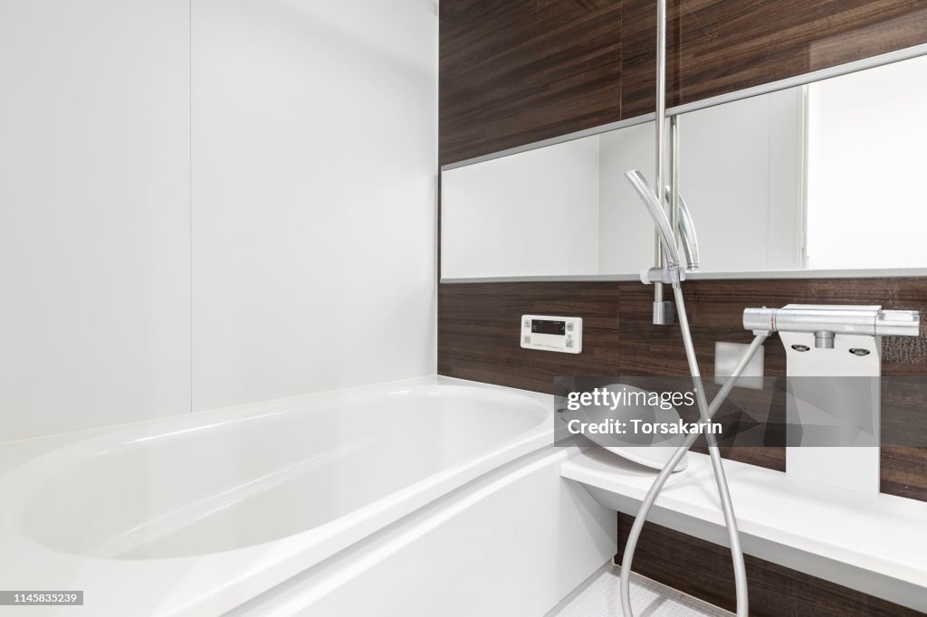 Large white bathtub in new modern bathroom