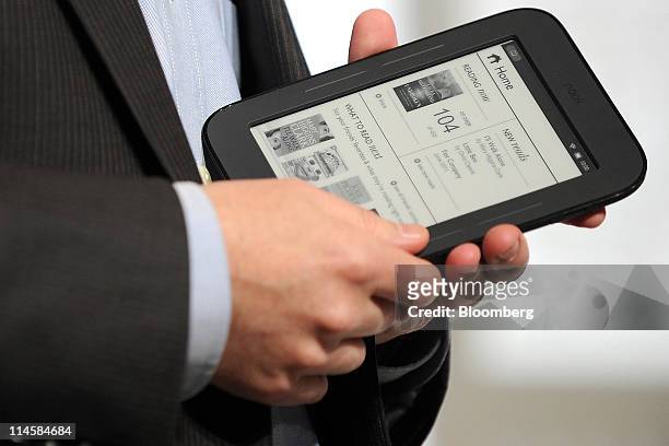 William Lynch, chief executive officer of Barnes & Noble Inc., displays the new Nook electronic reader during an event in New York, U.S., on Tuesday,...