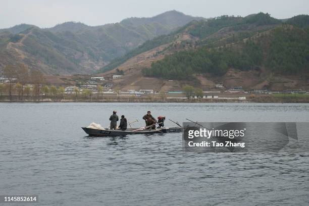 North Koreans ride boats in Yalu River, the border river shared with China, in Qingcheng, North Korea as seen from across the border on April 29,...