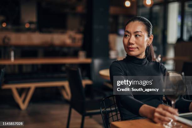 beautiful woman sitting in restaurant - asian luxury lifestyle stock pictures, royalty-free photos & images