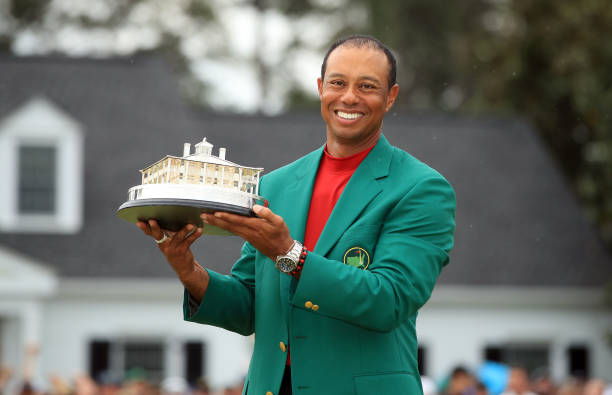 Tiger Woods of the United States celebrates with the Masters Trophy during the Green Jacket Ceremony after winning the Masters at Augusta National...