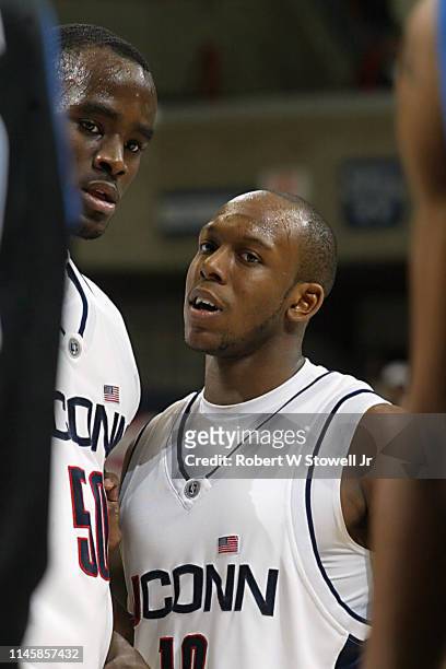 University of Connecticut players Emeka Okafor, left, and Taleik Brown confer during a game against Georgetown, Storrs, Connecticut, June 25, 2002.