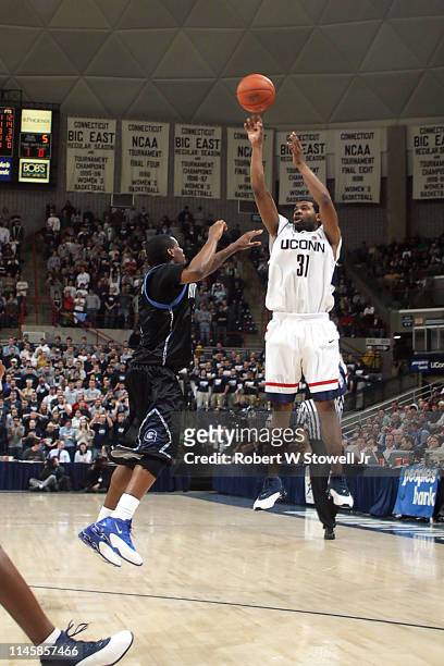University of Connecticut guald Rashad Anderson shoots a three pointer over the Georgetown defense in a game held, Storrs, Connecticut, January 14,...