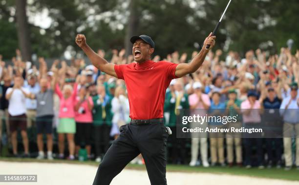 Tiger Woods of the United States celebrates on the 18th green after winning the Masters at Augusta National Golf Club on April 14, 2019 in Augusta,...