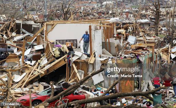 People try to salvage items from the Albrecht family home after it was destroyed when a massive tornado passed through the town killing at least 116...