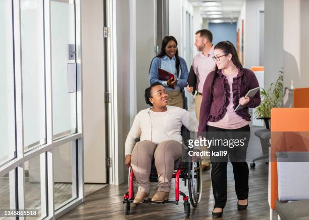 business people going to meeting, woman in wheelchair - wheelchair stock pictures, royalty-free photos & images
