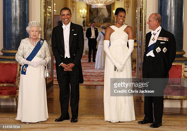 Queen Elizabeth II poses with U.S. President Barack Obama, his wife Michelle Obama and Prince Philip, Duke of Edinburgh in the Music Room of...