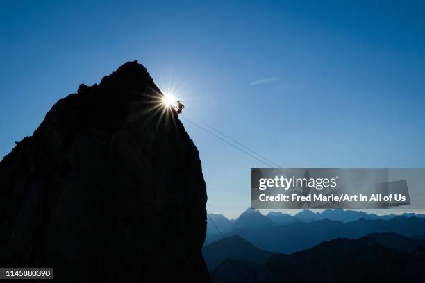 Man preparing his equipement for a base jump session in the french pyrenees, Nouvelle-aquitaine, Lescun, France on March 19, 2018 in Lescun, France.