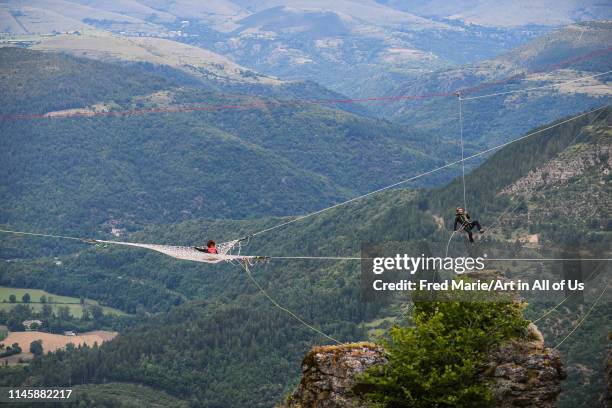 Sophie ducasse in a space net on the top of a cliff, Occitanie, Florac, France on July 2, 2017 in Florac, France.