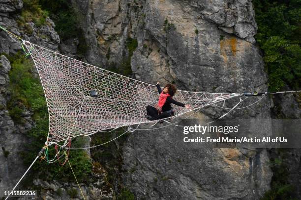 Sophie ducasse in a space net on the top of a cliff, Occitanie, Florac, France on July 2, 2017 in Florac, France.