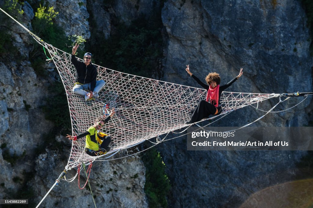 Sophie ducasse and matthias dandois in a space net on the top of a cliff, Occitanie, Florac, France...