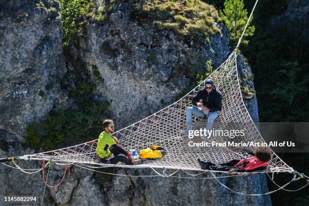 Sophie ducasse and matthias dandois in a space net on the top of a cliff, Occitanie, Florac, France on July 3, 2017 in Florac, France.