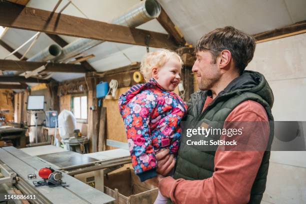 bring your baby to work day - blue collar worker family stock pictures, royalty-free photos & images