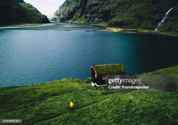 view of the saksun landscape at the faroe - thatched roof huts stock pictures, royalty-free photos & images