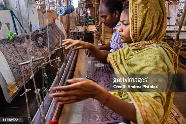 couple working at textile loom in dhaka, bangladesh - bangladesh culture stock pictures, royalty-free photos & images