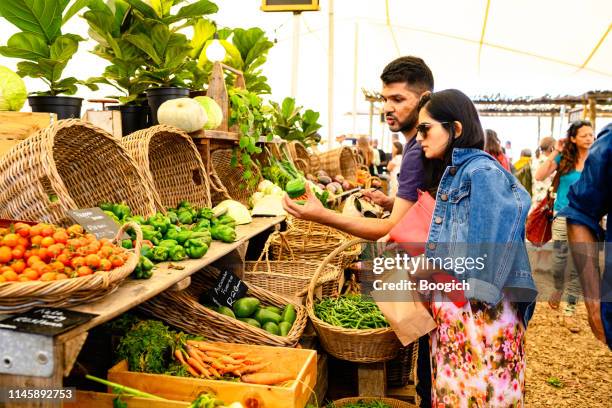 people shopping for produce en oranjezicht city farm market - farm produce market fotografías e imágenes de stock