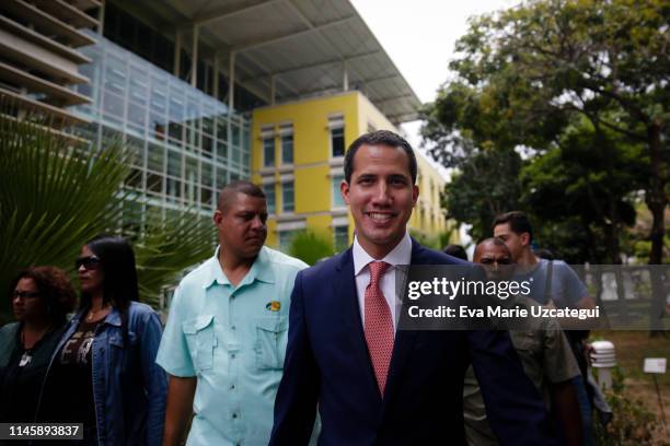 Venezuelan opposition leader Juan Guaido, recognized by many members of the international community as the country's rightful interim ruler, smiles...