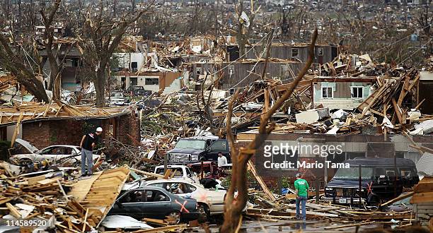 People try to salvage items from homes destroyed when a massive tornado passed through the town killing at least 116 people May 24, 2011 in Joplin,...