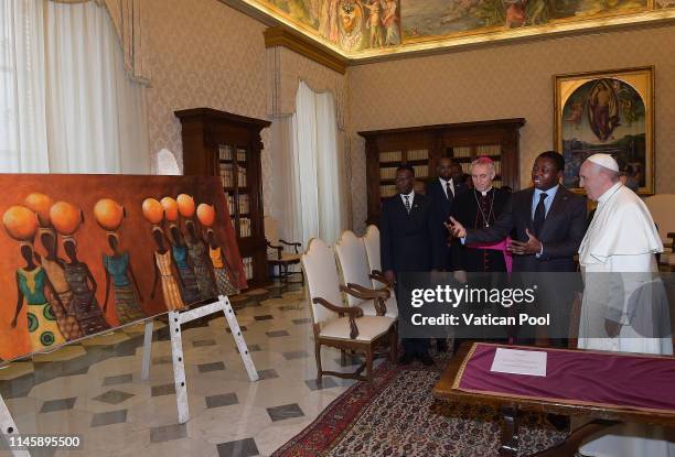 Pope Francis exchanges gifts with President of Togo Faure Essozimna Gnassingbe during an audience at the Apostolic Palace on April 29, 2019 in...