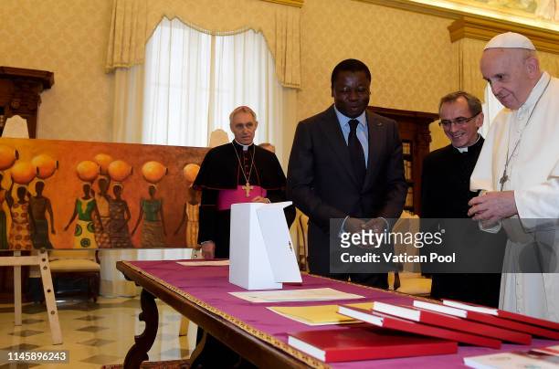 Pope Francis exchanges gifts with President of Togo Faure Essozimna Gnassingbe during an audience at the Apostolic Palace on April 29, 2019 in...