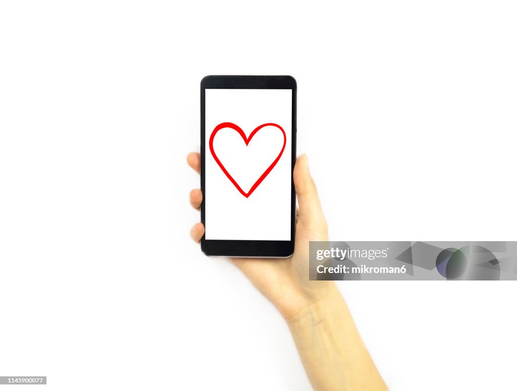 Hand holding a phone with a heart on it