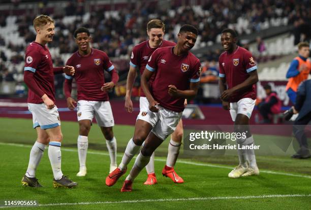 Ben Johnson of West Ham United celebrates with teammates after scoring his team's second goal during the Premier League 2 match between West Ham...