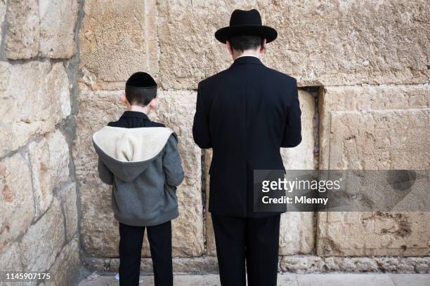 western wall praying jewish father and son jerusalem israel - orthodox judaism stock pictures, royalty-free photos & images