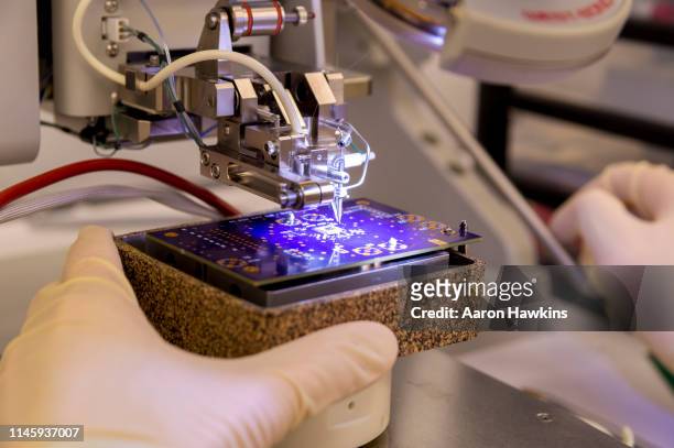 wire bonder used for attaching silicon chips and electronic devices to a pcb printed circuit board - physics research stock pictures, royalty-free photos & images