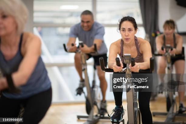 group exercise class - spin class stock pictures, royalty-free photos & images