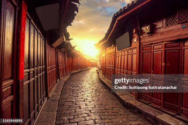 beautiful sunrise view of old chinese style building in old town of lijiang, yunnan , china. lijiang is most popular travel destination in china , yunnan province - world heritage stock pictures, royalty-free photos & images