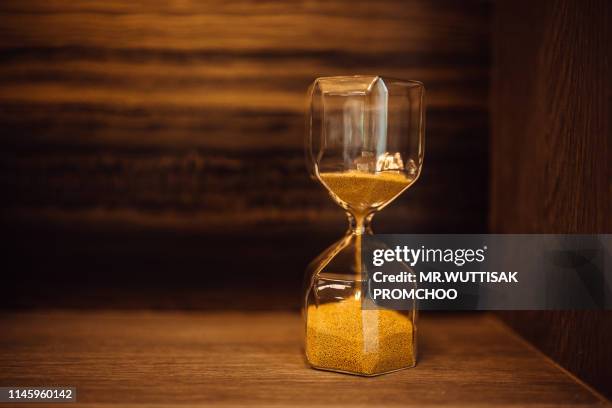 hourglass as time passing concept for business. - always on stock pictures, royalty-free photos & images