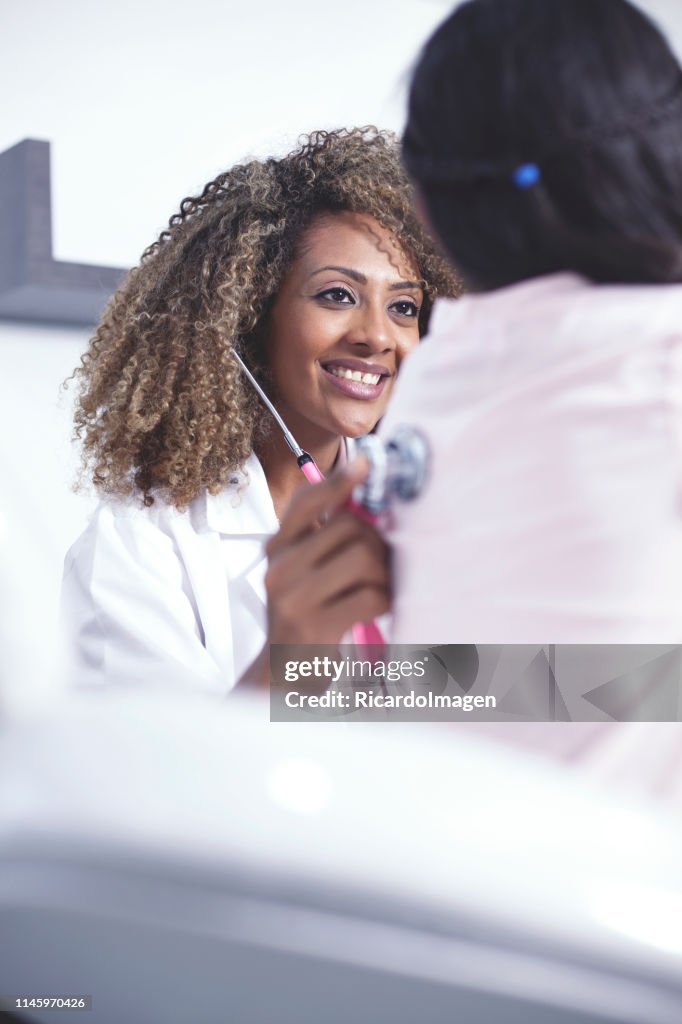 Female doctor checking a girl